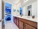 Double vanity bathroom with modern fixtures and a view of a space-themed bedroom at 1812 Sandy Park Trl, Kissimmee, FL 34747