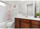 Clean bathroom with shower/tub combo and wood vanity at 1812 Sandy Park Trl, Kissimmee, FL 34747