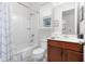 Bathroom with a tub shower combo and wood vanity at 1812 Sandy Park Trl, Kissimmee, FL 34747
