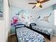 Themed bedroom with twin beds and ocean mural at 1812 Sandy Park Trl, Kissimmee, FL 34747