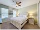 Guest bedroom with a queen-size bed and ceiling fan at 1812 Sandy Park Trl, Kissimmee, FL 34747