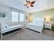 Bright bedroom with king bed and daybed, offering ample space at 1812 Sandy Park Trl, Kissimmee, FL 34747