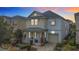 Two-story home with gray and beige exterior, two-car garage, and landscaping at 1812 Sandy Park Trl, Kissimmee, FL 34747