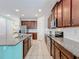 Modern kitchen with dark brown cabinets, granite countertops, and stainless steel appliances at 1812 Sandy Park Trl, Kissimmee, FL 34747