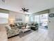 Open concept living room with large windows and access to the pool area at 1812 Sandy Park Trl, Kissimmee, FL 34747