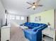 Open living area showcasing a sectional sofa and ceiling fan at 1812 Sandy Park Trl, Kissimmee, FL 34747