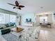 Open living room with light teal walls, a comfortable seating area, and a dining area at 1812 Sandy Park Trl, Kissimmee, FL 34747