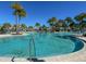 Resort-style pool with palm trees and lounge chairs at 1812 Sandy Park Trl, Kissimmee, FL 34747