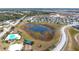 Aerial view of community with homes, pool, and pond at 215 Annabelle Way, Davenport, FL 33837