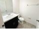 Small half bathroom with toilet and vanity at 215 Annabelle Way, Davenport, FL 33837