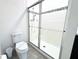 Bathroom with toilet and shower with glass enclosure at 215 Annabelle Way, Davenport, FL 33837
