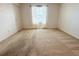 Bright bedroom with carpeted floor and window at 215 Annabelle Way, Davenport, FL 33837