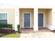 Two-story townhome with gray doors and manicured landscaping at 215 Annabelle Way, Davenport, FL 33837