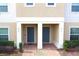 Two-story townhome with gray doors and a brick walkway at 215 Annabelle Way, Davenport, FL 33837