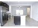Modern kitchen with stainless steel appliances and island at 215 Annabelle Way, Davenport, FL 33837