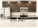 Kitchen features stainless steel appliances and granite countertops at 215 Annabelle Way, Davenport, FL 33837