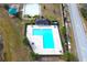 L-shaped community pool with surrounding patio at 215 Annabelle Way, Davenport, FL 33837