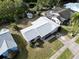 House with a gray roof, surrounded by trees and other houses at 219 Macon Way, St Cloud, FL 34769