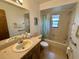 Clean bathroom with shower/tub combo, vanity, and grab bars at 219 Macon Way, St Cloud, FL 34769