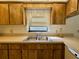 Kitchen sink and countertop area with wood cabinets at 219 Macon Way, St Cloud, FL 34769