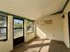 Bright sunroom featuring multiple windows and carpet flooring at 219 Macon Way, St Cloud, FL 34769