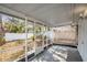 View of the home's screened-in patio overlooking the backyard and white vinyl fence at 2215 Weber St, Lakeland, FL 33801