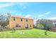 Large backyard with grassy lawn and two-story house at 223 Largovista Dr, Oakland, FL 34787