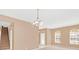 Living room with stairs, chandelier, and two windows at 223 Largovista Dr, Oakland, FL 34787