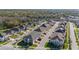 Aerial view of townhomes in an attractive neighborhood with well-maintained streets, landscaping, and convenient parking at 2276 Centerra Loop, Kissimmee, FL 34741