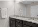 Bathroom with granite countertop, double sinks and dark cabinets at 2276 Centerra Loop, Kissimmee, FL 34741