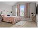 Bright bedroom with vaulted ceiling, large windows with curtains, and neutral carpet at 2276 Centerra Loop, Kissimmee, FL 34741