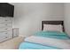 Clean bedroom with drawers, a comfy bed, soft blue bedding, and neutral carpet at 2276 Centerra Loop, Kissimmee, FL 34741