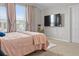 Comfortable bedroom with plush carpet, soft pink bedding, and a large window at 2276 Centerra Loop, Kissimmee, FL 34741