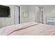 Cozy bedroom featuring soft pink bedding, neutral walls, and a mounted television at 2276 Centerra Loop, Kissimmee, FL 34741