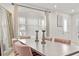 Elegant dining room featuring modern decor, a large mirror, and ample natural light at 2276 Centerra Loop, Kissimmee, FL 34741