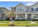 Charming two-story townhome featuring a covered front porch and well-maintained landscaping at 2276 Centerra Loop, Kissimmee, FL 34741