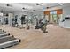 A well-equipped gym features modern exercise machines and ample natural light, creating an inviting workout space at 2276 Centerra Loop, Kissimmee, FL 34741