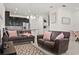 Inviting living room with sofas, tile flooring, and an open layout leading to the kitchen at 2276 Centerra Loop, Kissimmee, FL 34741