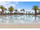 A serene community pool offers residents a refreshing escape, complete with comfortable lounge chairs and shaded areas at 2276 Centerra Loop, Kissimmee, FL 34741