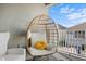 Relaxing porch with comfy egg chair with cushions and string lights overhead at 2276 Centerra Loop, Kissimmee, FL 34741