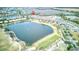 An aerial view showcases a large lake and golf course in the Solivita community at 2285 Palm Tree Dr, Kissimmee, FL 34759