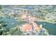 Aerial view of a resort-style community with waterways, lush greenery, and orange-tiled buildings at 2285 Palm Tree Dr, Kissimmee, FL 34759