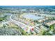 Aerial view of a residential area featuring a beautiful lake and various community amenities at 2285 Palm Tree Dr, Kissimmee, FL 34759