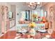 Dining room with a chandelier and table set with dishes at 2285 Palm Tree Dr, Kissimmee, FL 34759
