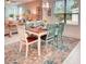 Bright dining room with a wooden table set for six, large windows, and a view of the cozy living space at 2285 Palm Tree Dr, Kissimmee, FL 34759