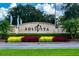 Landscaped Solivita entrance sign with colorful plants and palm trees at 2285 Palm Tree Dr, Kissimmee, FL 34759