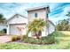 Charming exterior elevation with a well-manicured lawn and lush landscaping, showcasing curb appeal at 2285 Palm Tree Dr, Kissimmee, FL 34759