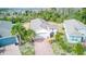 Aerial view of a charming single-Gathering home with well-maintained landscaping and a brick driveway at 2285 Palm Tree Dr, Kissimmee, FL 34759