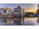 Beautiful waterfront architecture with stone accents and outdoor seating at 2285 Palm Tree Dr, Kissimmee, FL 34759