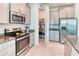 Well-equipped kitchen featuring gray cabinetry, stainless steel appliances, and a walk-in pantry at 2285 Palm Tree Dr, Kissimmee, FL 34759